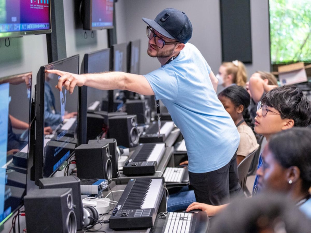 Instructor Pascal LeBouef pointing at a student's screen